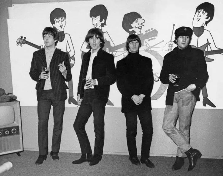 The Beatles with their cartoon likenesses from the ABC animated series · 1965